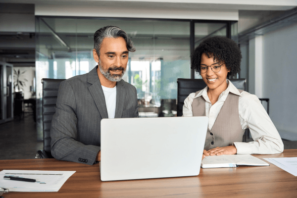 Business professionals around computer